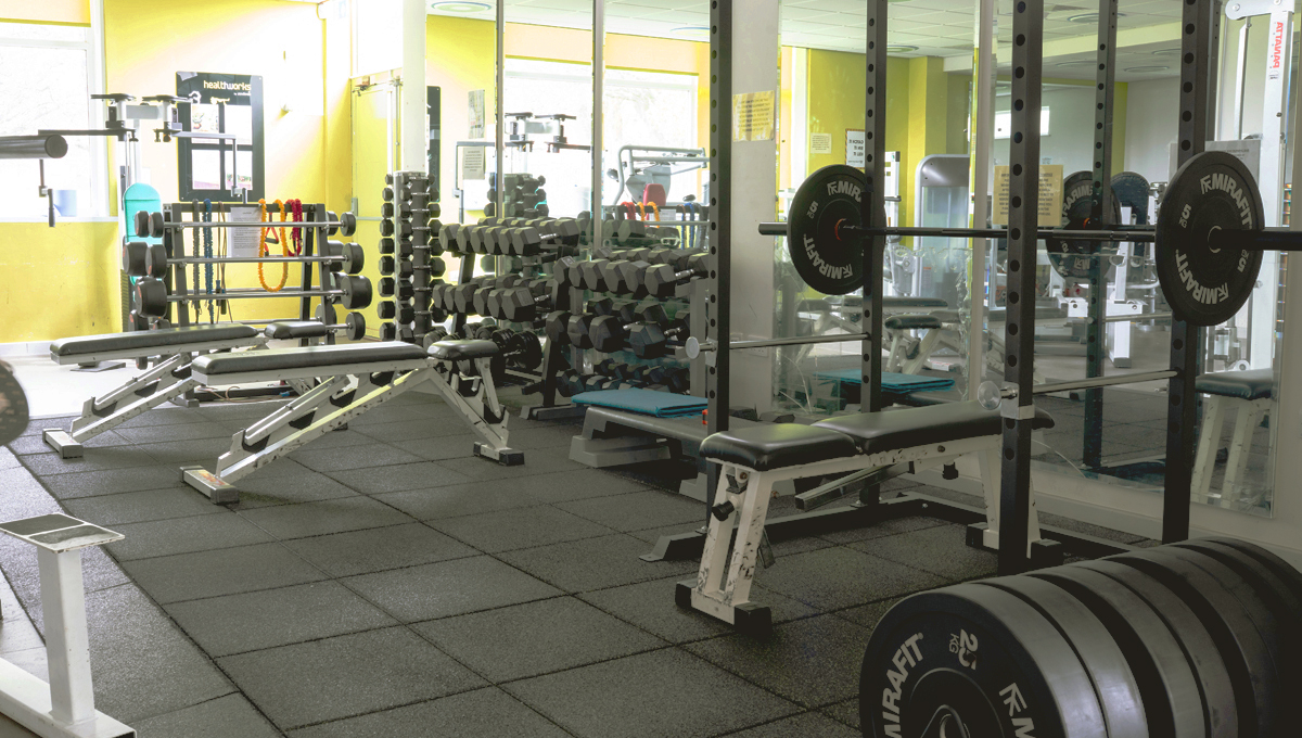 An empty gym with gym equipment.