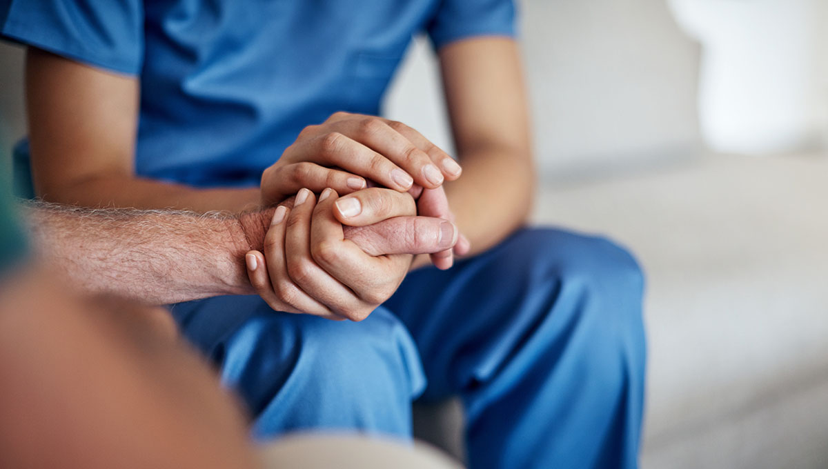 Cropped shot of a female carer consoling a senior patient at the nursing home