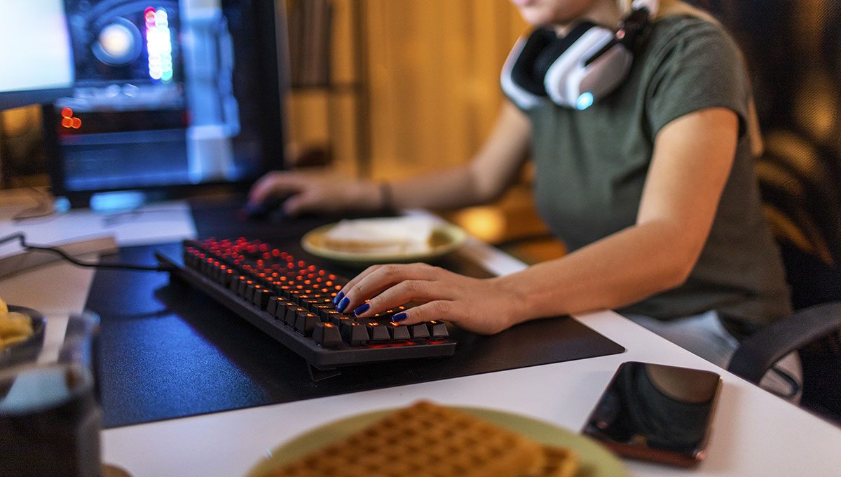 Young blonde working on her desktop computer