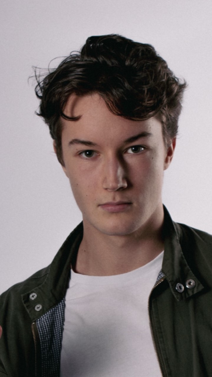 A headshot of a young man posing.