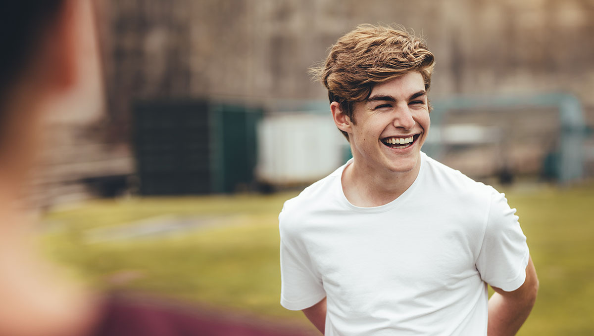 Boy smiling during physical training class in high school